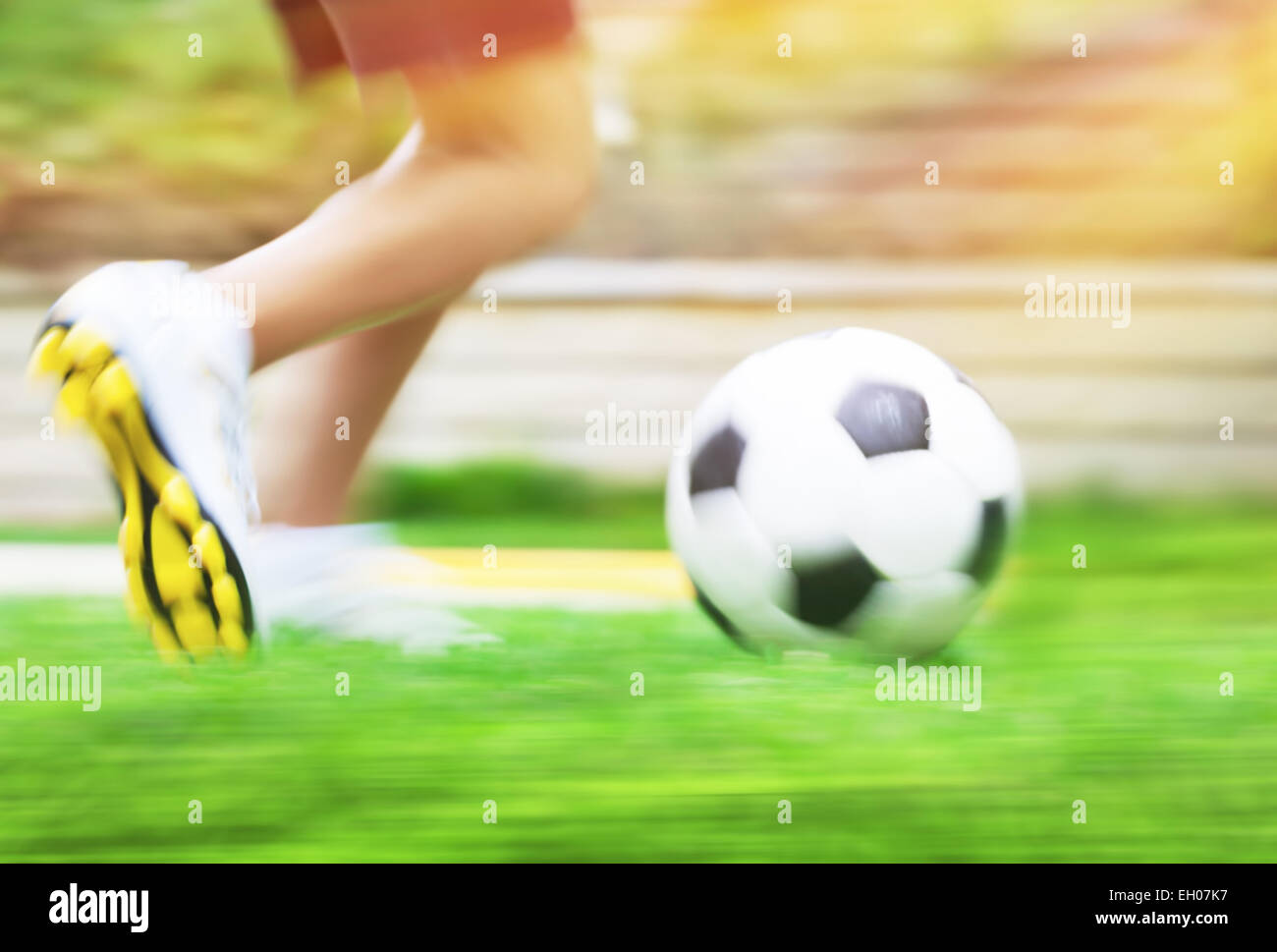 Football game slow motion, body part, sportive teen boy runs for ball