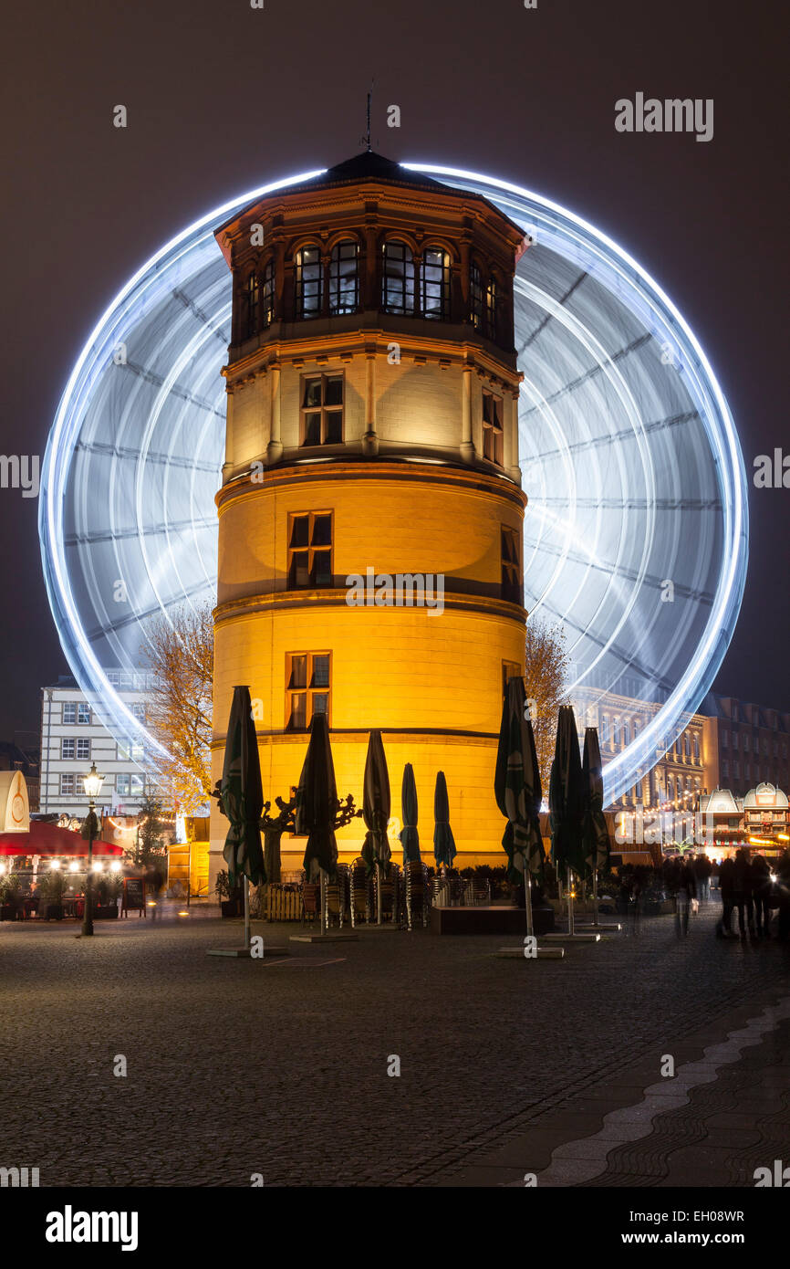 Germany, Duesseldorf, Burgplatz with donjon and ferris wheel at night Stock Photo