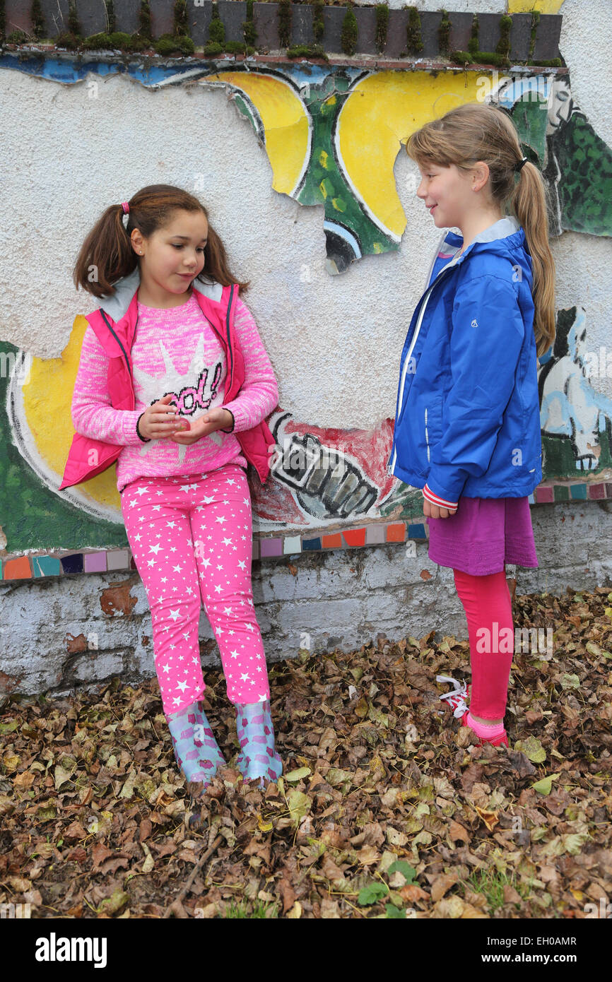 Girls playing in urban park - posed by models Stock Photo