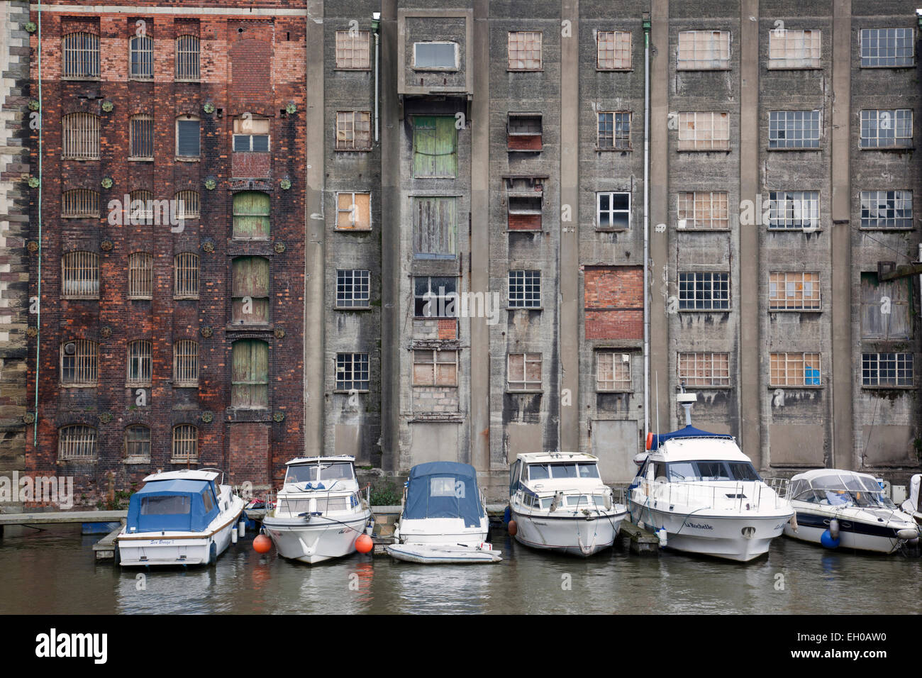 Old warehouses Bristol harbourside with small boats moored alongside,  Redcliffe Wharf, City of Bristol, England, UK Stock Photo