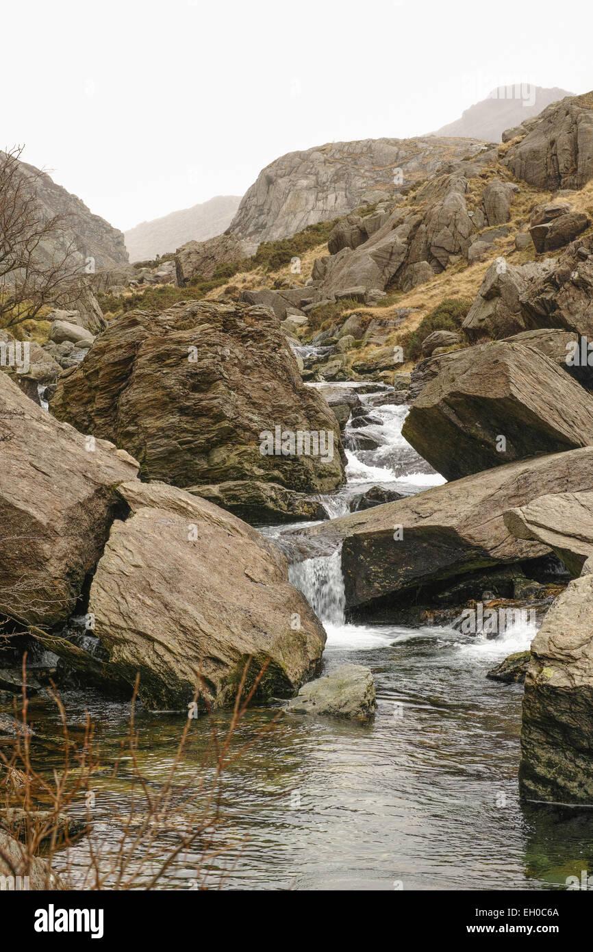 The mountain stream named nant Peris, which flows down the Llanberis pass from mount Snowdon to the village of Llanberis, Wales. Stock Photo
