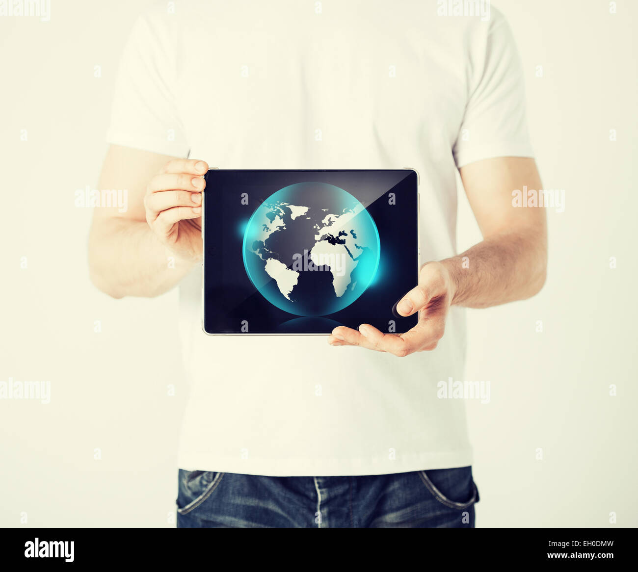 man hands holding tablet pc with sign of globe Stock Photo