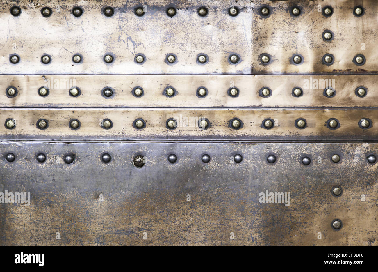 Background copper rivets, detail of a wall decorated with copper, shiny