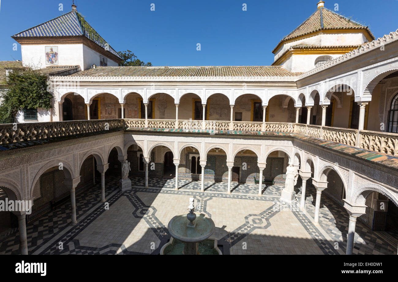 Casa de Pilatos courtyard with a fountain surrounded by busts of Spanish kings. an Andalisian palace in Seville Stock Photo