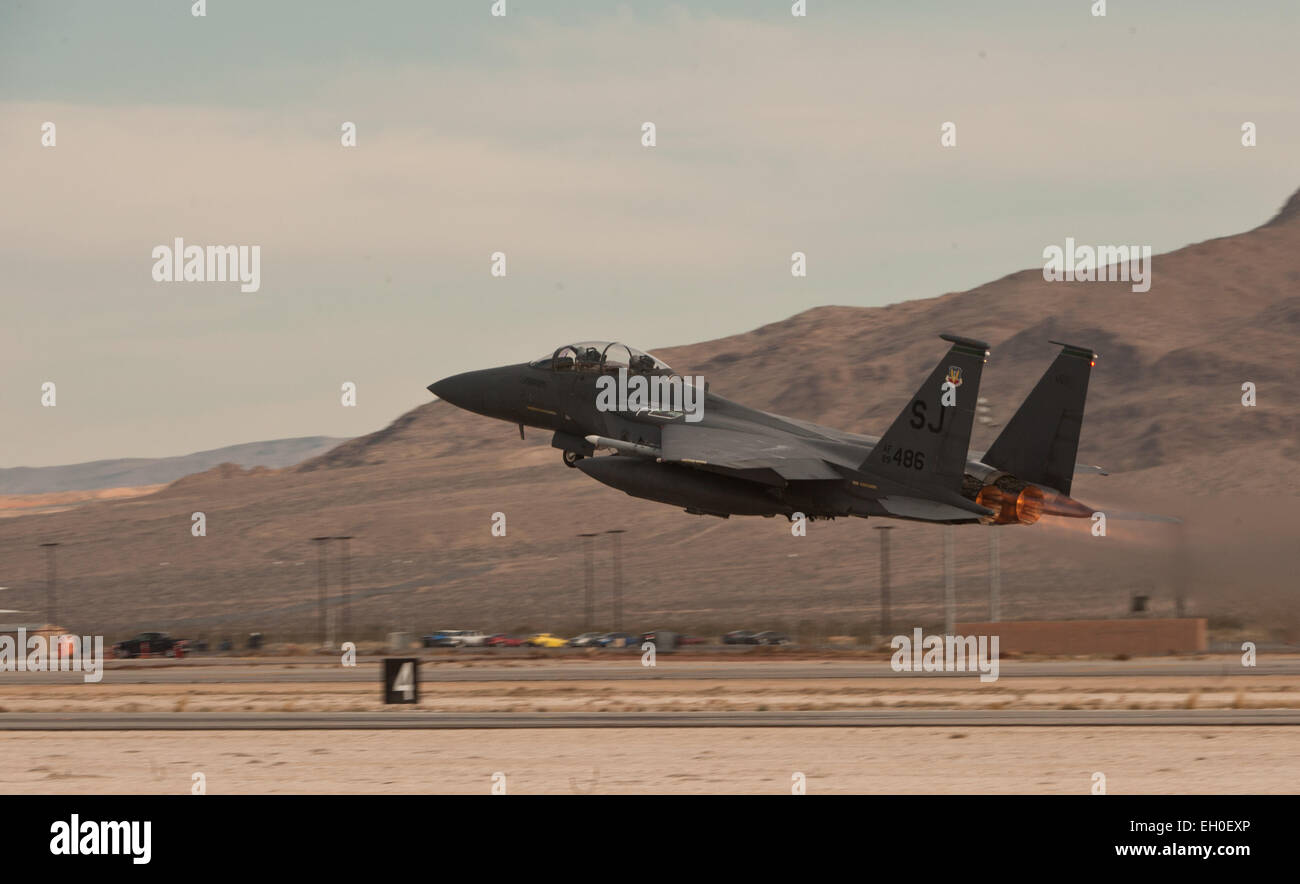 An F-15E Strike Eagle takes off Feb. 4, 2015, from Nellis Air Force Base, Nev., to participate in a Red Flag 15-1 training sortie over the Nevada Test and Training Range. Various units from around the Air Force, joint branches and coalition partners converge on Nellis AFB three to four times a year to take part in the exercise, which simulates large-scale live, virtual and constructive warfare. The F-15E is assigned to the 335th Fighter Squadron at Seymour Johnson Air Force Base, N.C. Stock Photo