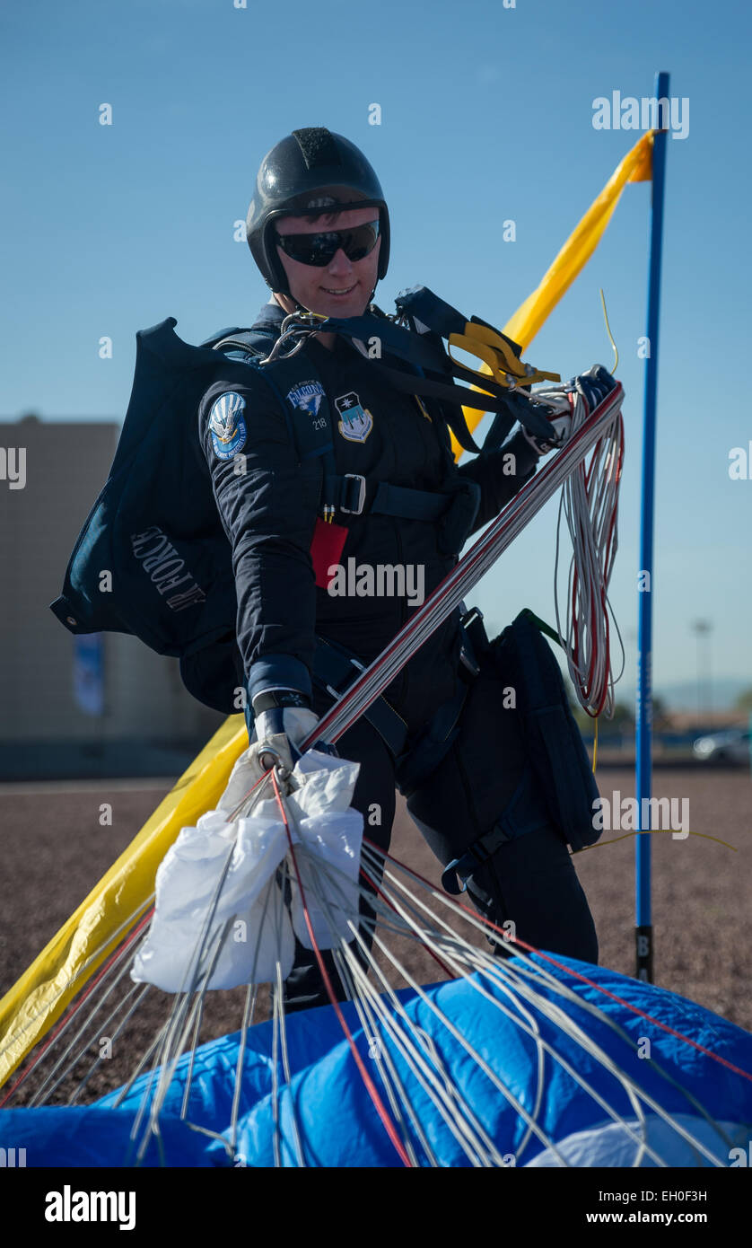 Cadet 2nd Class Dylan Smith, 98th Flying Training Squadron Wings of Blue parachutist, a Valley Central, CA native, gathers his equipment after preforming in an aerial demonstration for the opening ceremonies of the Air Force Wounded Warrior (AFW2) 2015 Trials  on Nellis Air Force Base, NV, February 27. The AFW2 Trials are an adaptive sports event designed to promote the mental and physical well-being of seriously ill and injured military members and veterans. More than 105 wounded, ill or injured service men and women from around the country will compete for a spot on the 2015 U.S. Air Force W Stock Photo