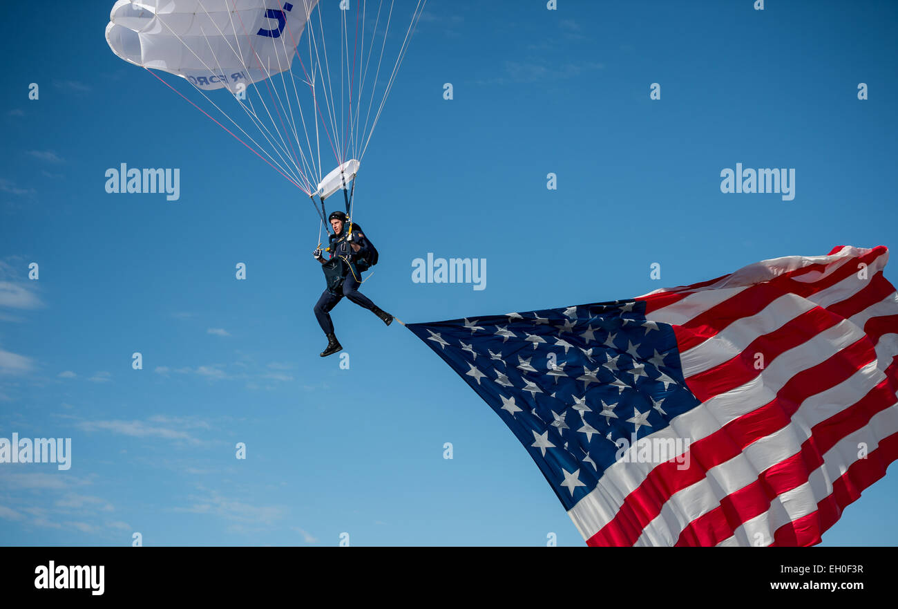 Cadet 1st Class Josh Burres, 98th Flying Training Squadron Wings of Blue parachutist, a Greensboro, NC native, flies the U.S. flag during an aerial demonstration for the opening ceremonies of the Air Force Wounded Warrior (AFW2) 2015 Trials  on Nellis Air Force Base, NV, February 27. The AFW2 Trials are an adaptive sports event designed to promote the mental and physical well-being of seriously ill and injured military members and veterans. More than 105 wounded, ill or injured service men and women from around the country will compete for a spot on the 2015 U.S. Air Force Wounded Warrior Team Stock Photo