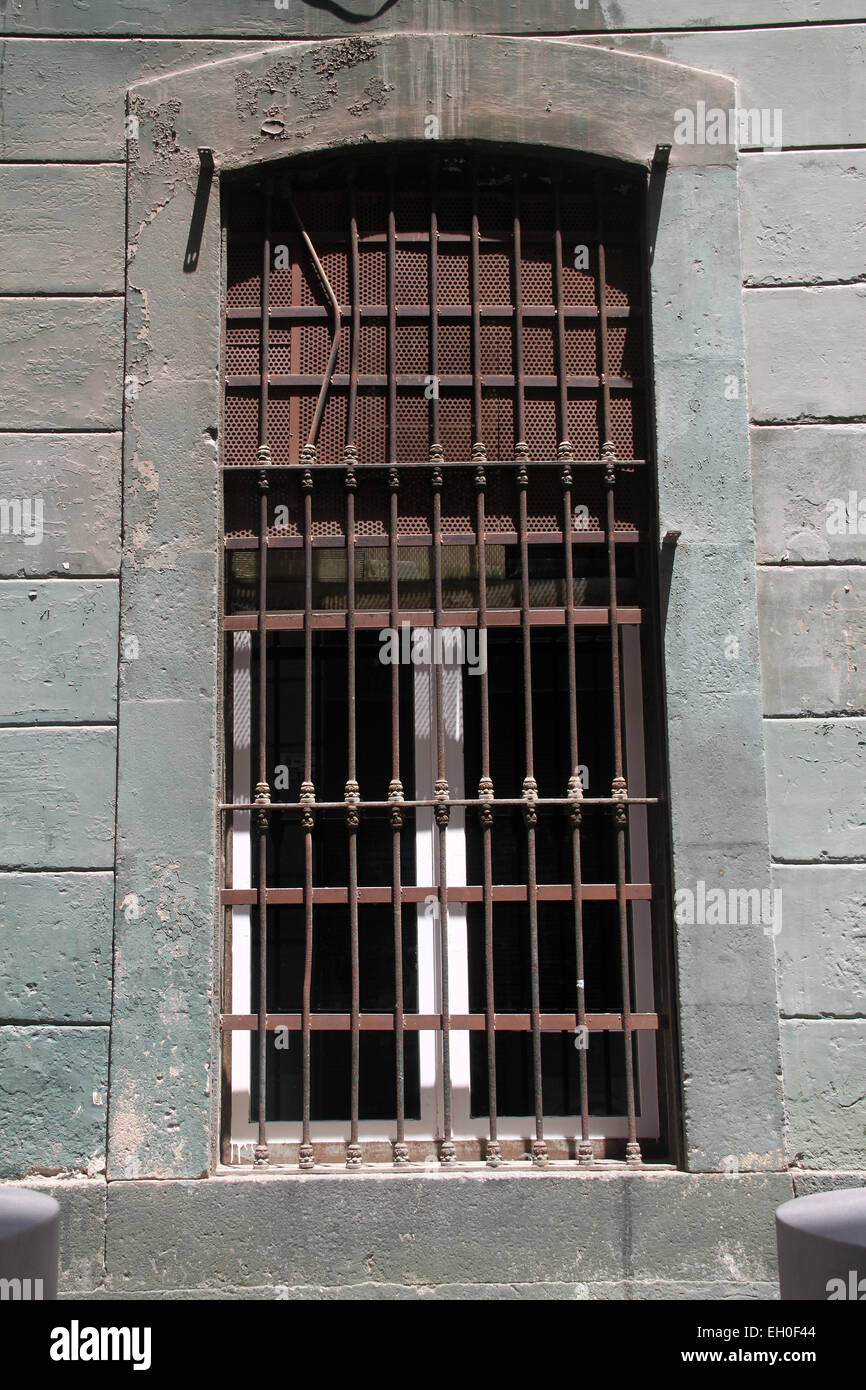 Old window with bars in El Raval neighbourhood in the centre of