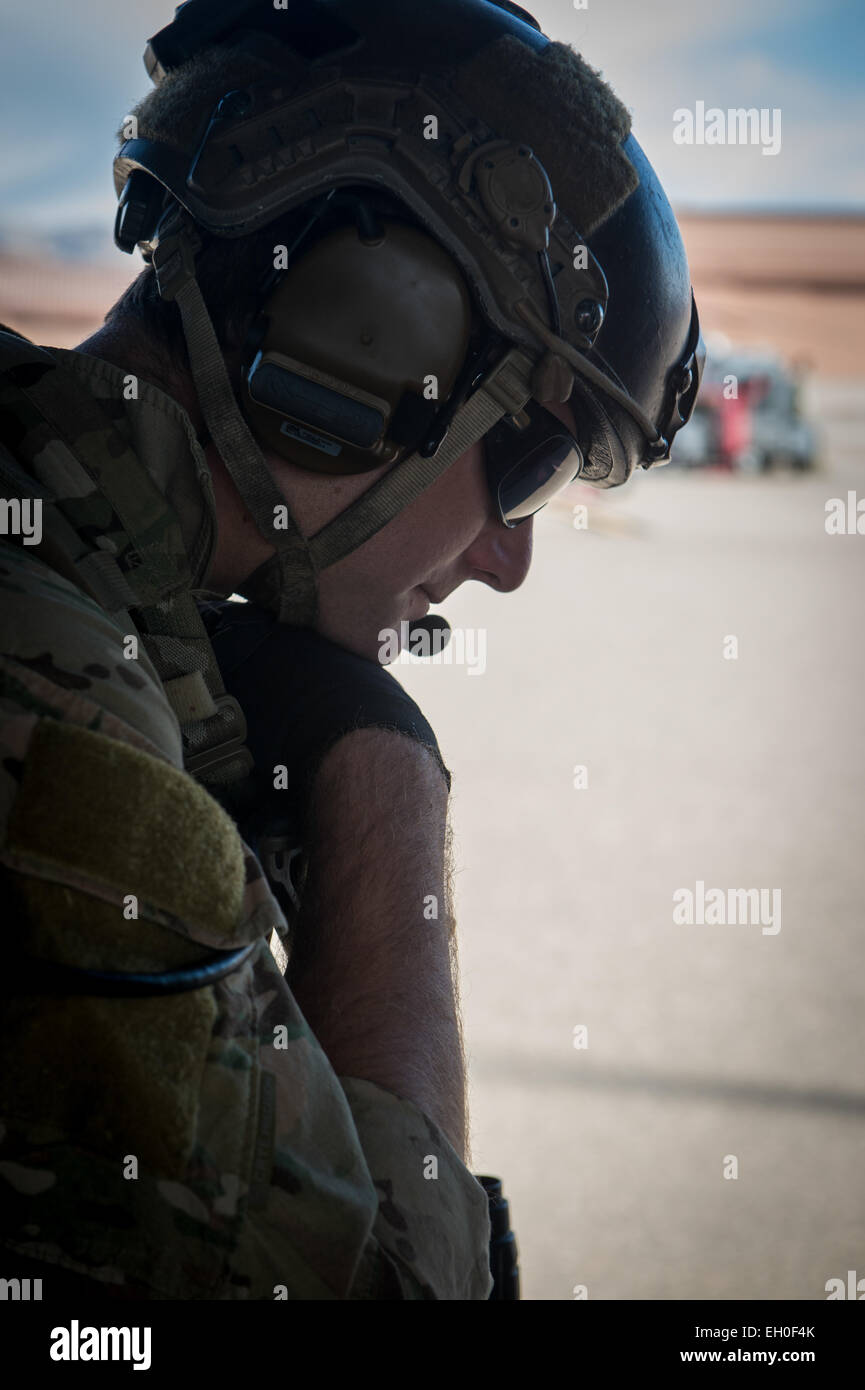 A member of the 58th Rescue Squadron waits to take-off in a UH-60 Black Hawk from the 66th Rescue Squadron Feb. 27, 2015 at Nellis Air Force Base, Nev. The 66th RQS along with the 58th Rescue Squadron assisted in the opening ceremonies of the 2015 Air Force Wounded Warrior Trials. The Air Force Trials are an adaptive sports event designed to promote the mental and physical well-being of seriously ill and injured military members and veterans. More than 105 wounded, ill or injured service men and women from around the country will compete for a spot on the 2015 U.S. Air Force Wounded Warrior Te Stock Photo