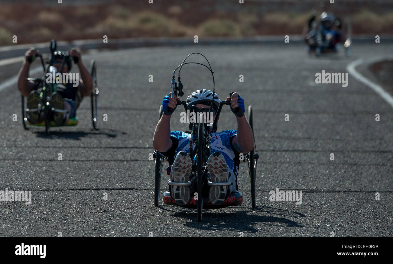 Three Men's Hand Cycle 10k contestants round a curve during the Air Force Wounded Warrior 2015 Trials on Nellis Air Force Base, Nev., February 28. The Air Force Trials are an adaptive sports event designed to promote the mental and physical well-being of seriously ill and injured military members and veterans. More than 105 wounded, ill or injured service men and women from around the country will compete for a spot on the 2015 U.S. Air Force Wounded Warrior Team which will represent the Air Force at adaptive sports competitions throughout the year. Stock Photo