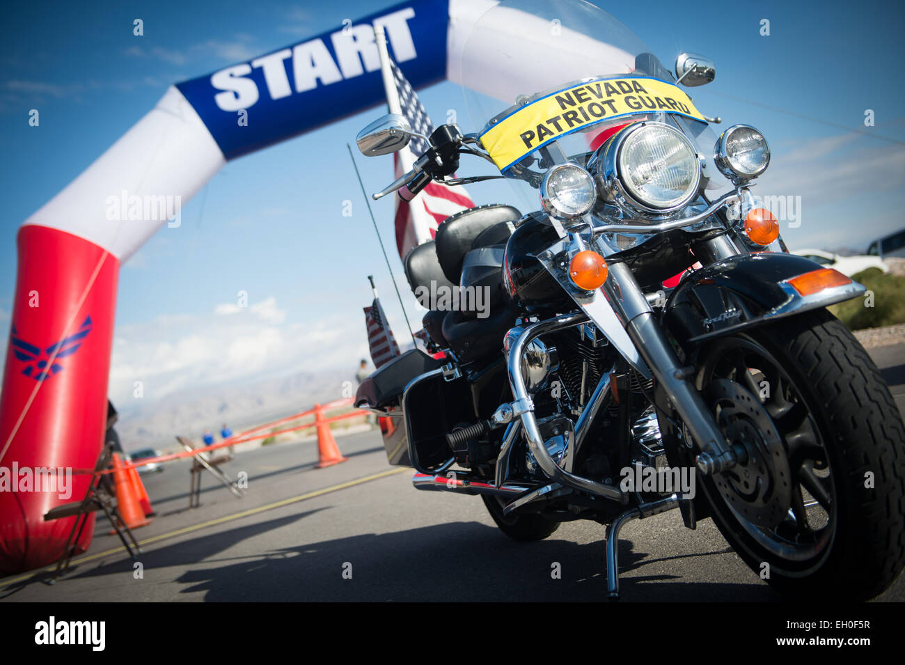 A motorcycle belonging to Peter Doyle, member of the Nevada Patriot Guard, sits at the start of the Air Force Wounded Warrior Trials cycling competition held at Nellis Air Force Base, Nev. Feb. 28, 2015. The Nevada Patriot Guard escorted the participants of the cycling competition around the track. The Air Force Trials are an adaptive sports event designed to promote the mental and physical well-being of seriously ill and injured military members and veterans. More than 105 wounded, ill or injured service men and women from around the country will compete for a spot on the 2015 U.S. Air Force Stock Photo