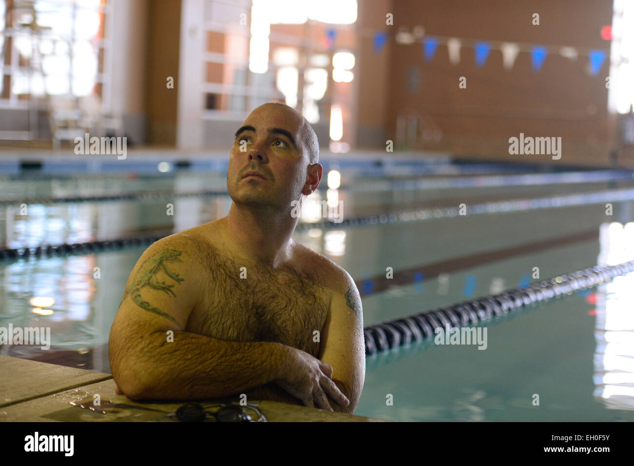 Jason Caswell, a 2015 Air Force Wounded Warrior swimmer, receives swimming instructions during the Air Force Wounded Warrior team trials on Nellis AFB, Nev. Feb. 28, 2015. The Air Force Trials are an adaptive sports event designed to promote the mental and physical well-being of seriously ill and injured military members and veterans. More than 105 wounded, ill or injured service men and women from around the country will compete for a spot on the 2015 U.S. Air Force Wounded Warrior Team which will represent the Air Force at adaptive sports competitions throughout the year. Stock Photo