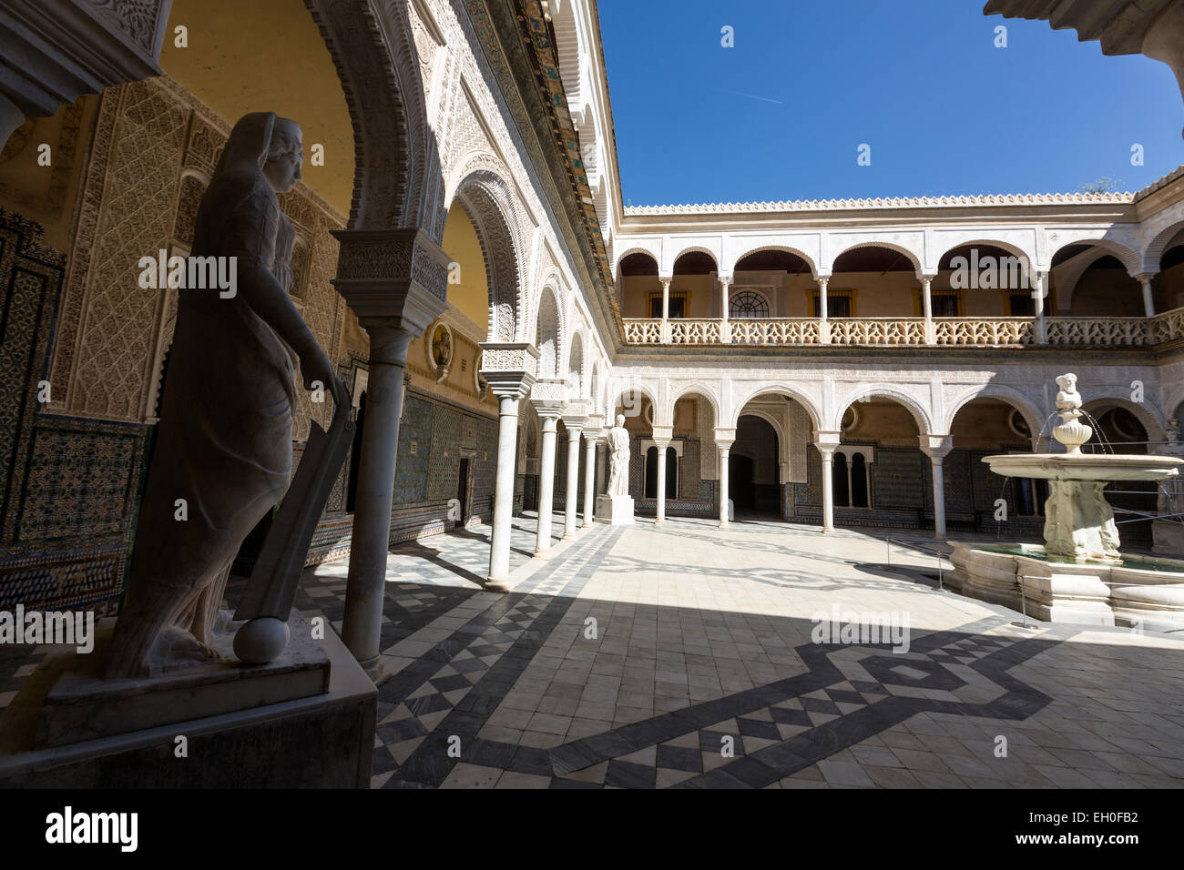 Casa de Pilatos courtyard with a fountain surrounded by busts of Spanish kings. an Andalisian palace in Seville Stock Photo