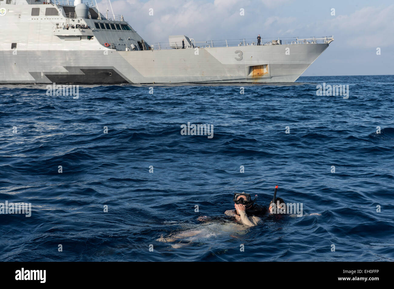 SOUTH CHINA SEA (Feb. 26, 2015) Gunner’s Mate 1st Class Thomas Culbertson, right, from Media, Pa., a search and rescue swimmer assigned to Surface Warfare Mission Package, Detachment 1, embarked aboard the littoral combat ship USS Fort Worth (LCS 3), performs a cross chest carry on Boatswain’s Mate 2nd Class James Rutherford, from Galveston, Texas, a search and rescue swimmer assigned to Fort Worth, during a training exercise. Stock Photo