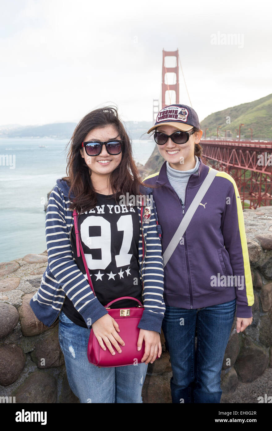 Asian women, posing for photograph, tourists, visitors, visiting, north side of Golden Gate Bridge, Vista Point, city of Sausalito, California Stock Photo