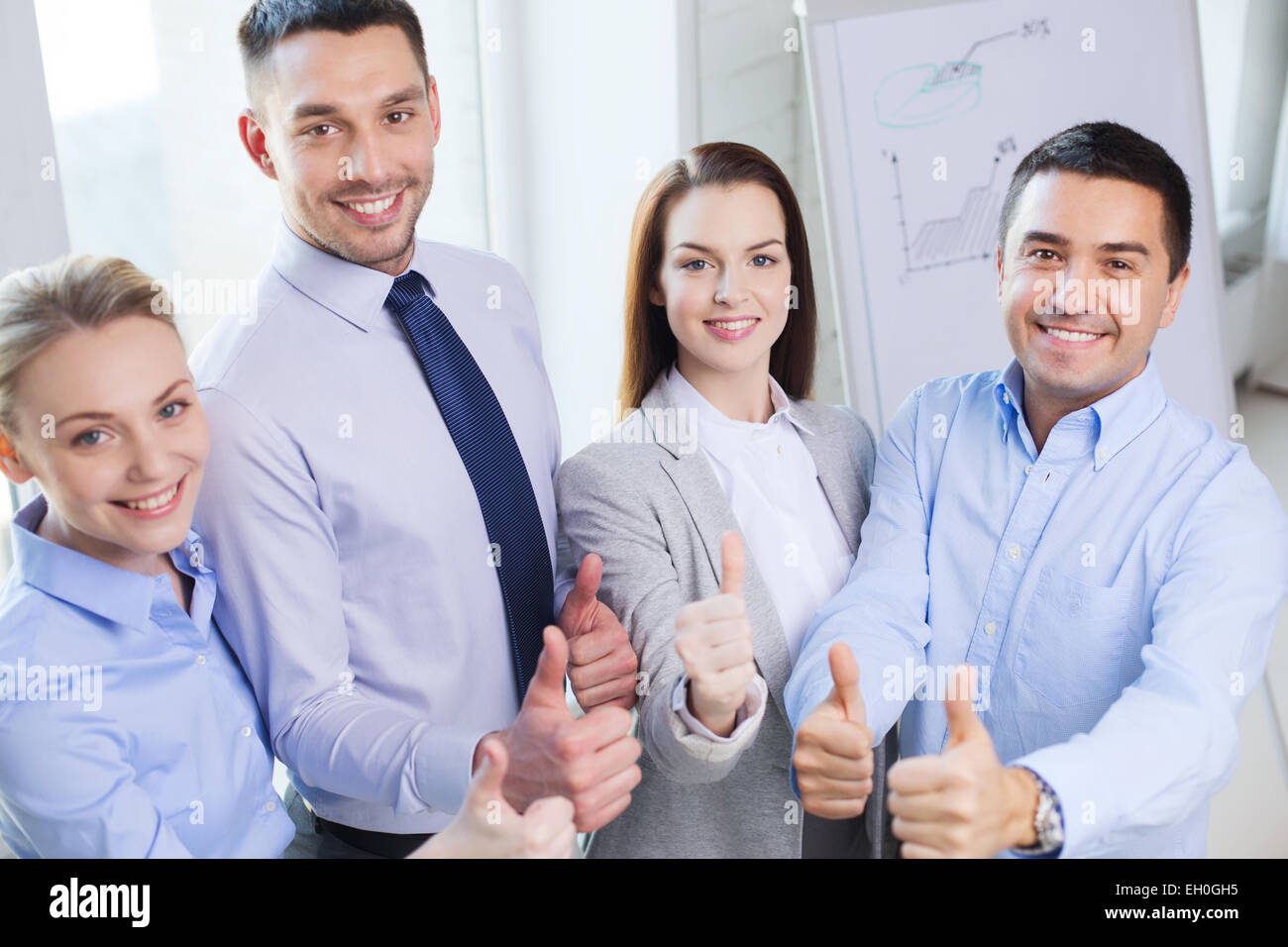 smiling business people showing thumbs up Stock Photo - Alamy