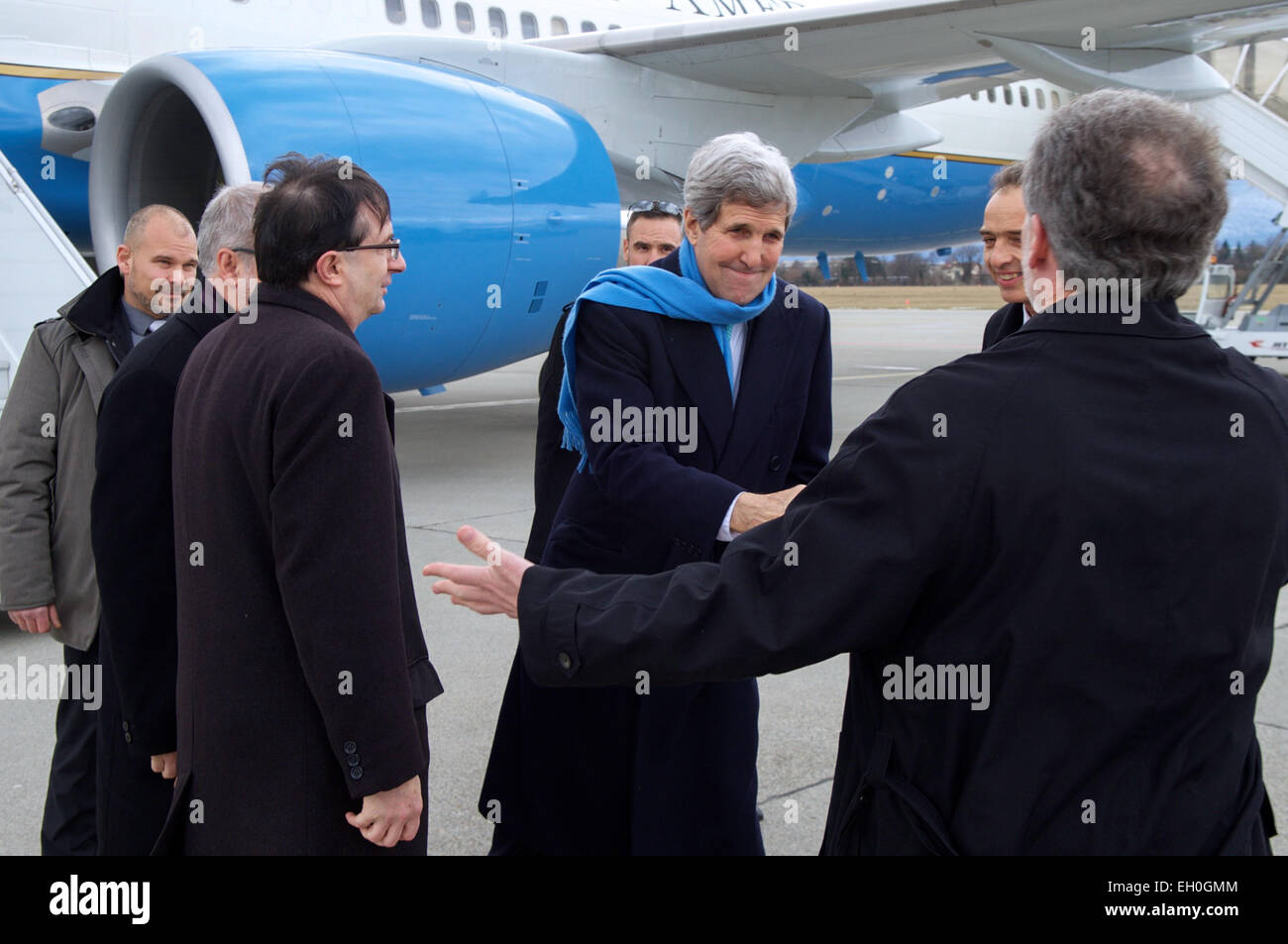 U.S. Secretary of State John Kerry shakes hands with Peter Mulrean, Deputy Chief of Mission for the United States Mission to the United Nations in Geneva, as he arrives in Geneva, Switzerland, on February 22, 2015, for a round of talks with Iranian officials about the future of their nuclear program. Stock Photo