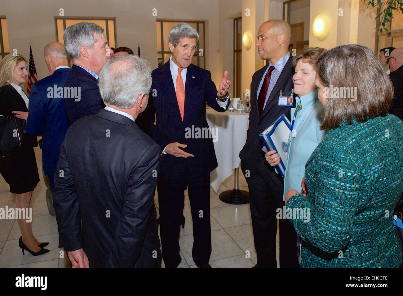 U.S. Secretary of State John Kerry speaks with, clockwise from bottom. Senator Bob Corker of Tennessee, Senator Sheldon Whitehouse of Rhode Island, Senator Cory Booker of New Jersey, Senator Jeanne Shaheen of New Hampshire, and Assistant Secretary of State for European and Eurasian Affairs Toria Nuland on February 7, 2015, in Munich, Germany, as he attends a reception given by Vice President Joe Biden for a Congressional Delegation to the Munich Security Conference. Stock Photo