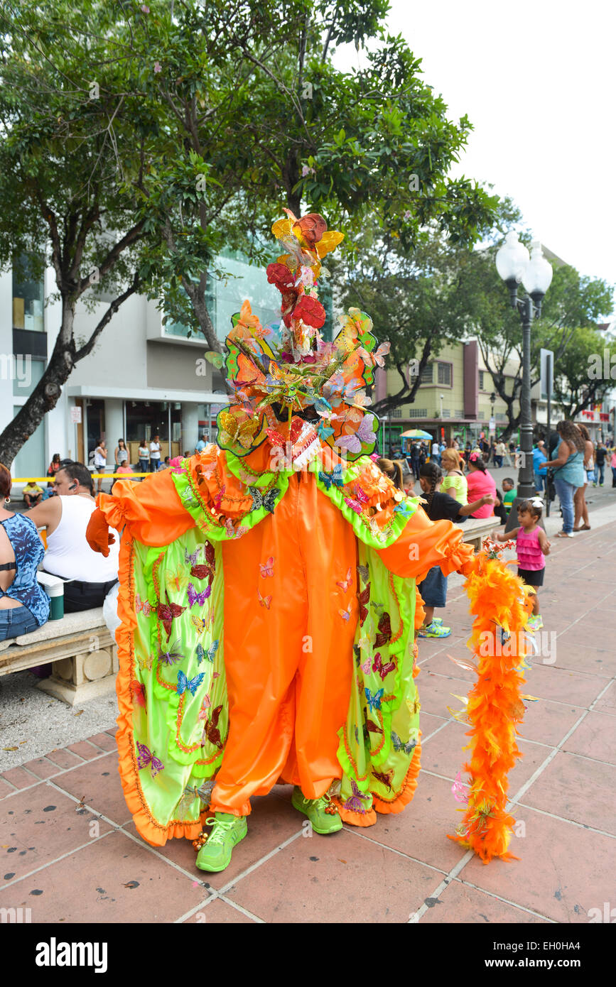 Brightly colored masked Vejigante during carnival in the streets of Ponce, Puerto Rico. February 2015. Stock Photo