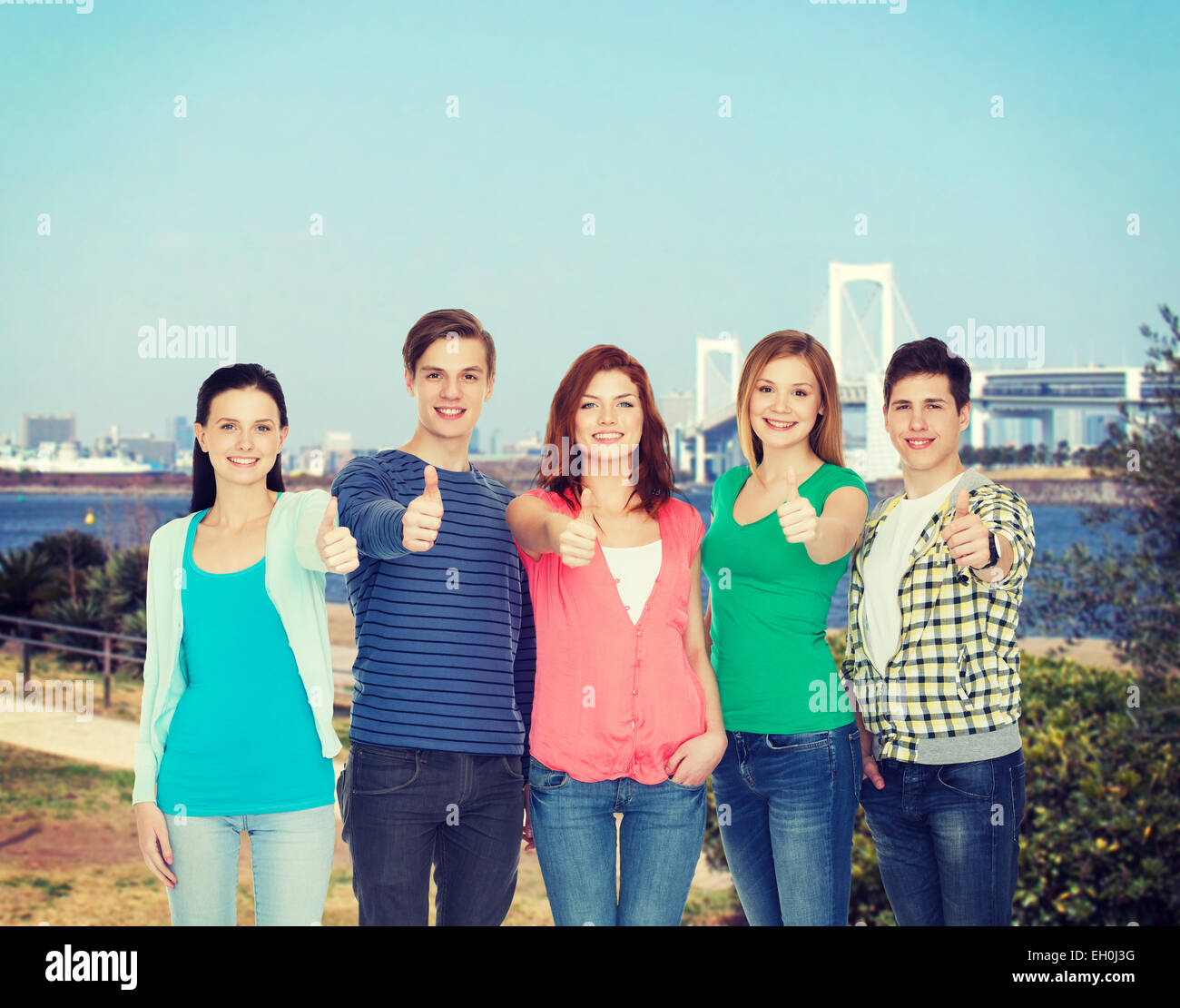 group of smiling students showing thumbs up Stock Photo - Alamy