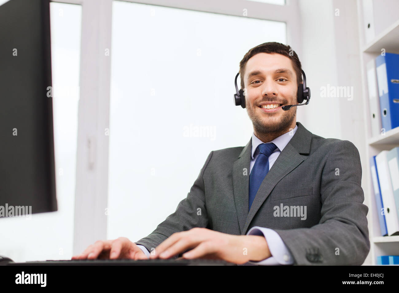 Similing Person Computer smiling businessman with computer in office Stock Photo - Alamy
