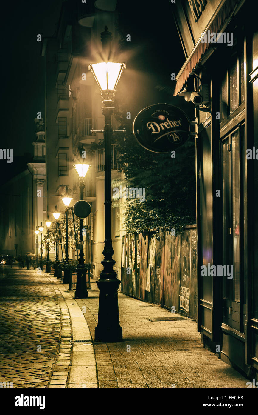 Street lights, lamp post light the quiet cobblestone street in the quiet  historic city of Budapest Hungary Stock Photo - Alamy