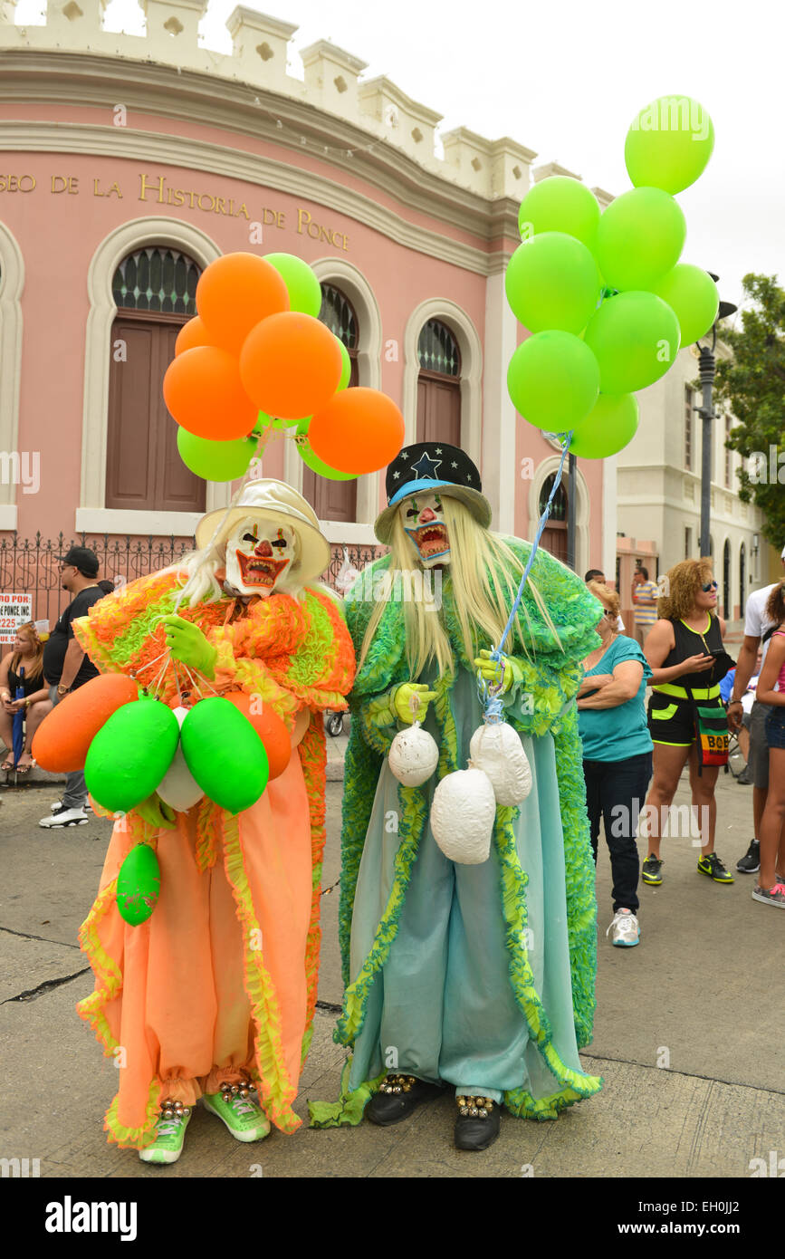 Two masked and scary Vejigates posing during carnival in Ponce, Puerto Rico. February 2015. Stock Photo