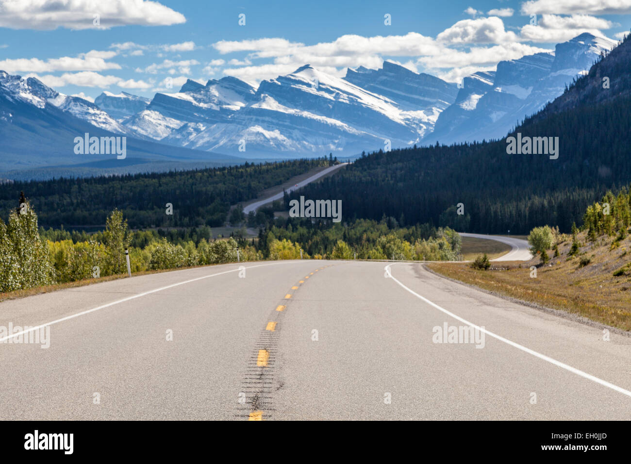 A two-lane paved Alberta David Thompson Highway #11 through the snow-covered Rocky Mountains, viewing of the beautiful landscape Stock Photo