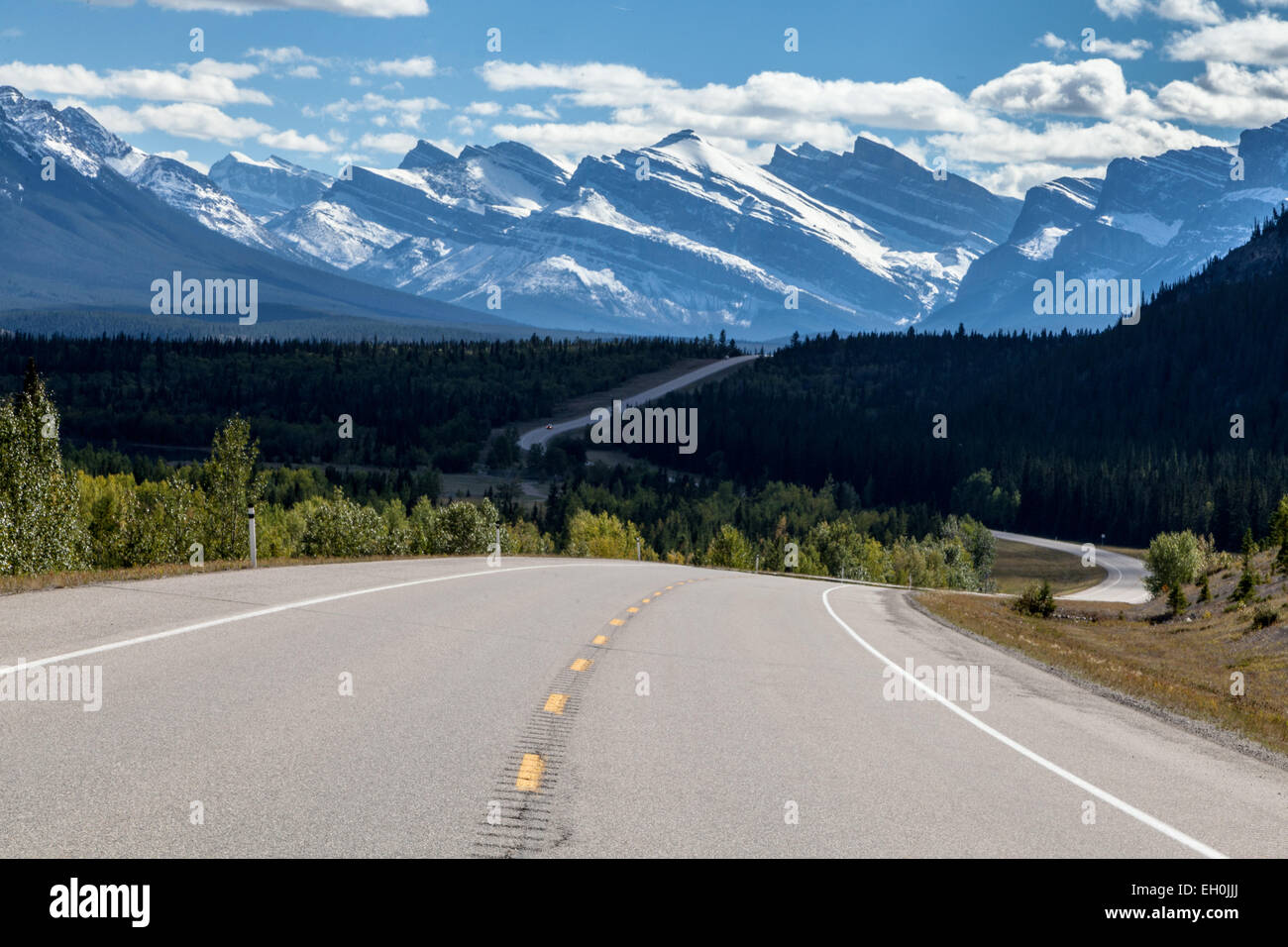 A two-lane paved Alberta David Thompson Highway #11 through the snow-covered Rocky Mountains, viewing of the beautiful landscape Stock Photo