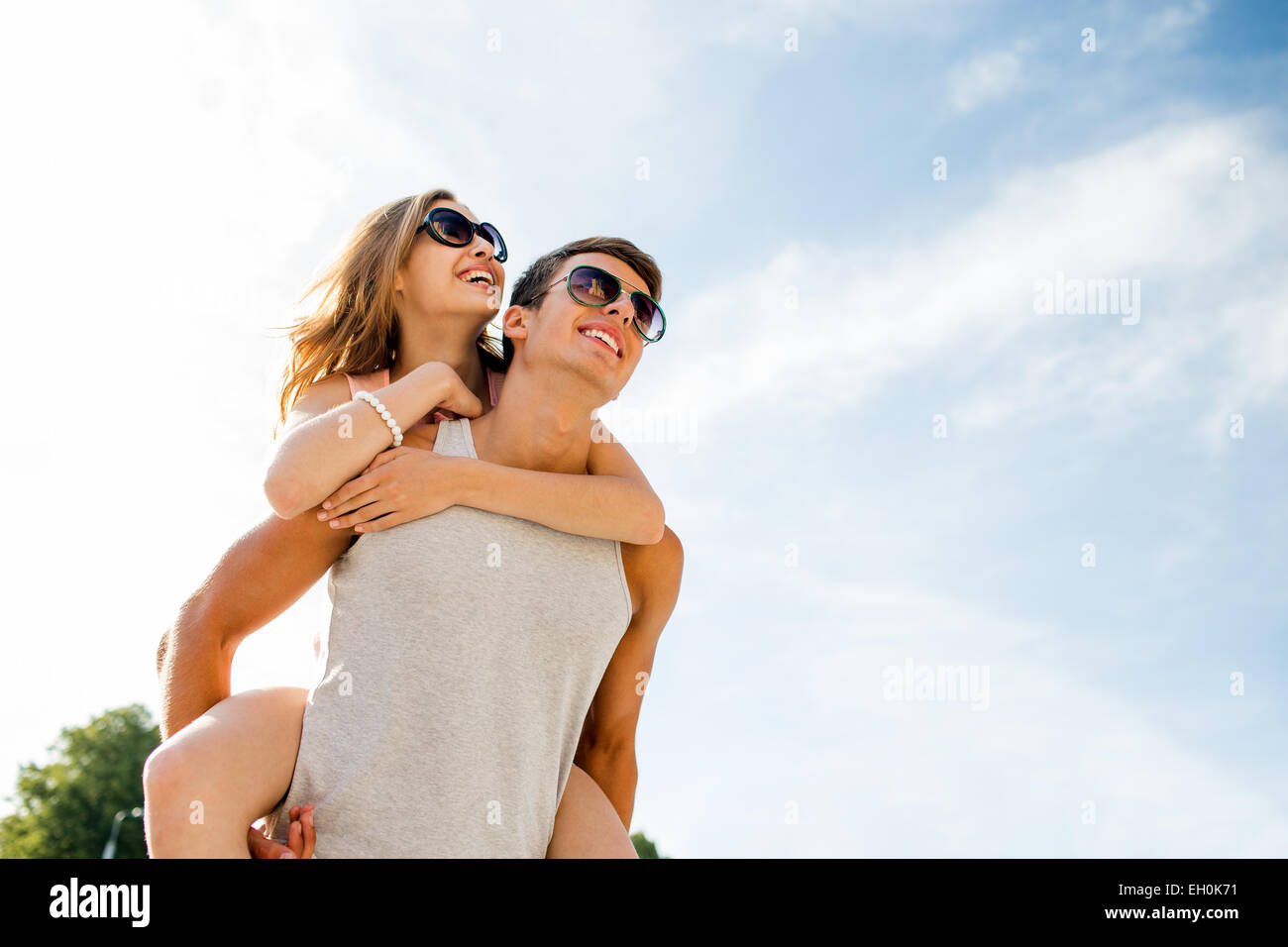 smiling couple having fun over sky background Stock Photo - Alamy