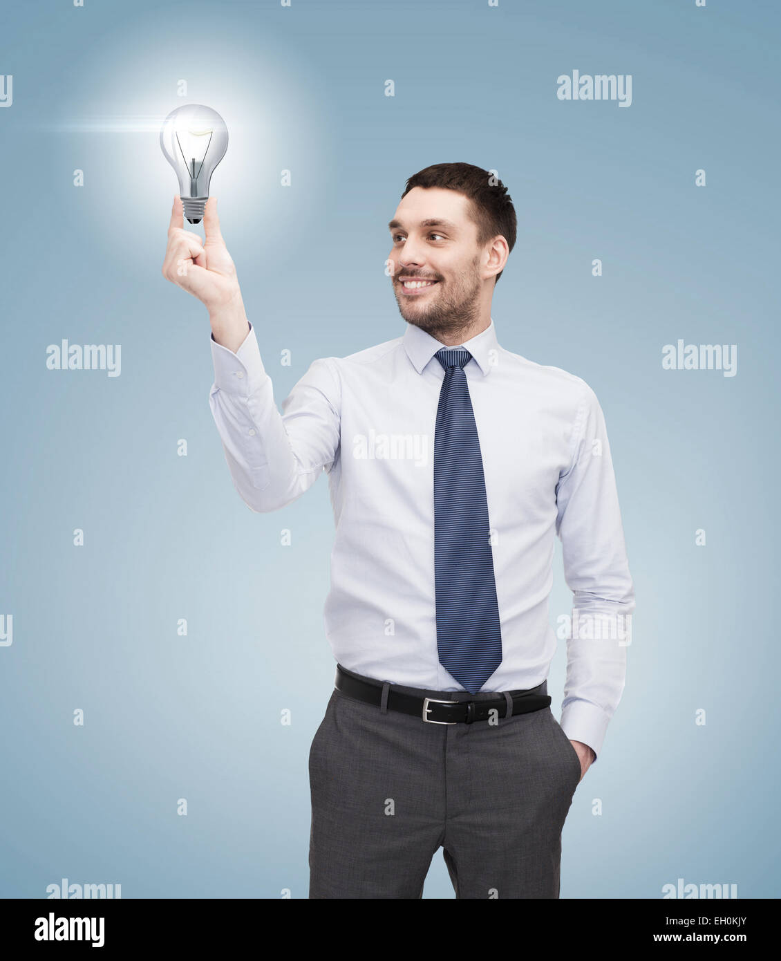 handsome businessman holding light bulb Stock Photo - Alamy