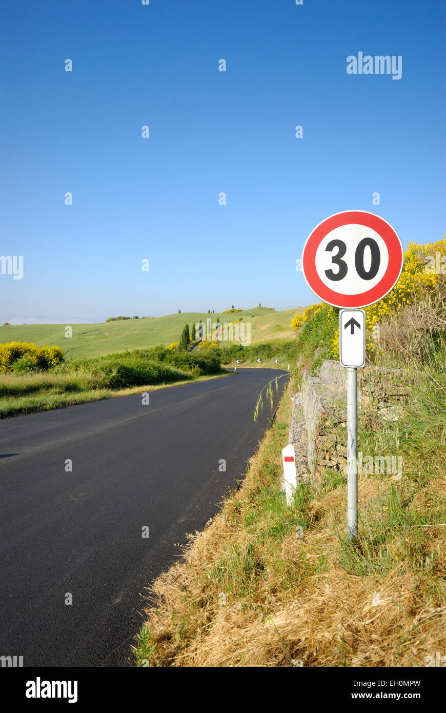 Speed limit sign on highway through landscape, Tuscany, Italy Stock