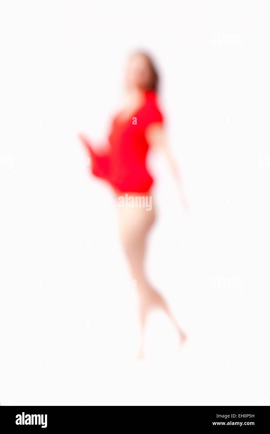 Abstract Out of Focus Image of a Woman in Red Dress Stock Photo