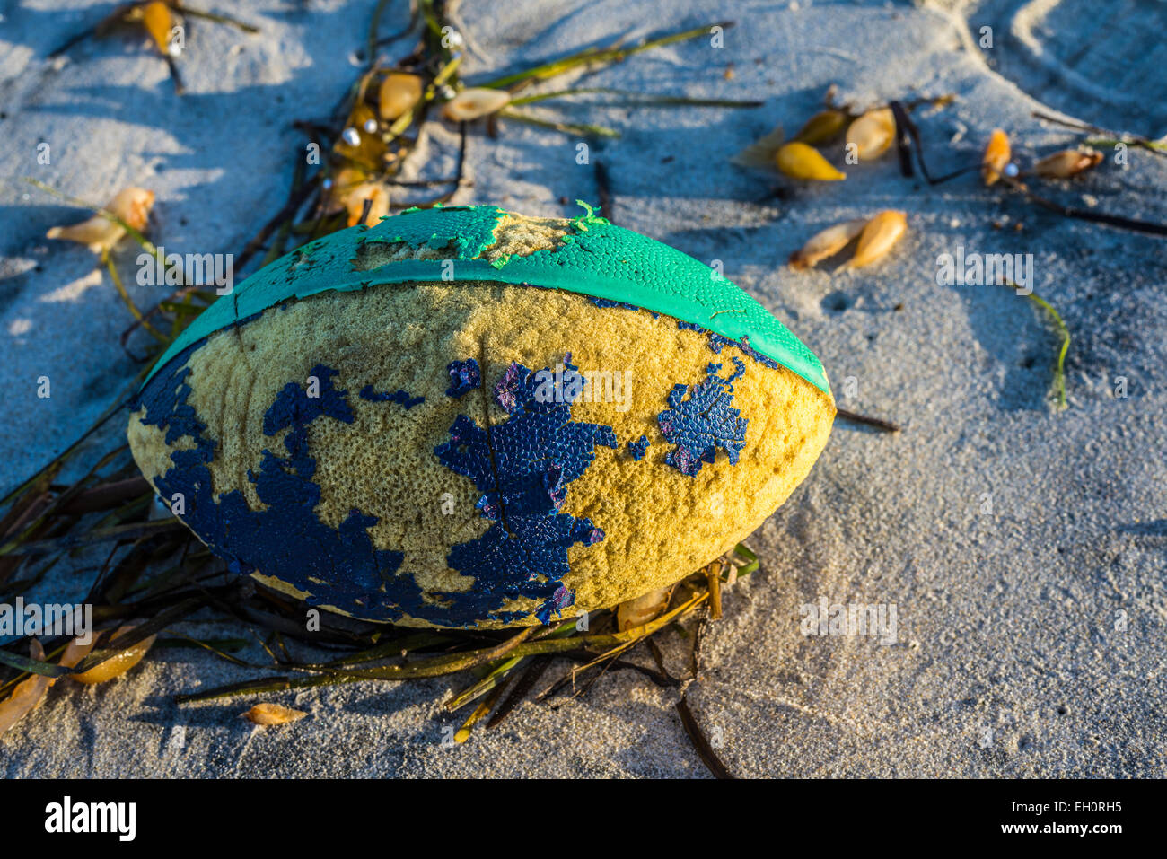 Styrofoam football lying on a beach. Stock Photo