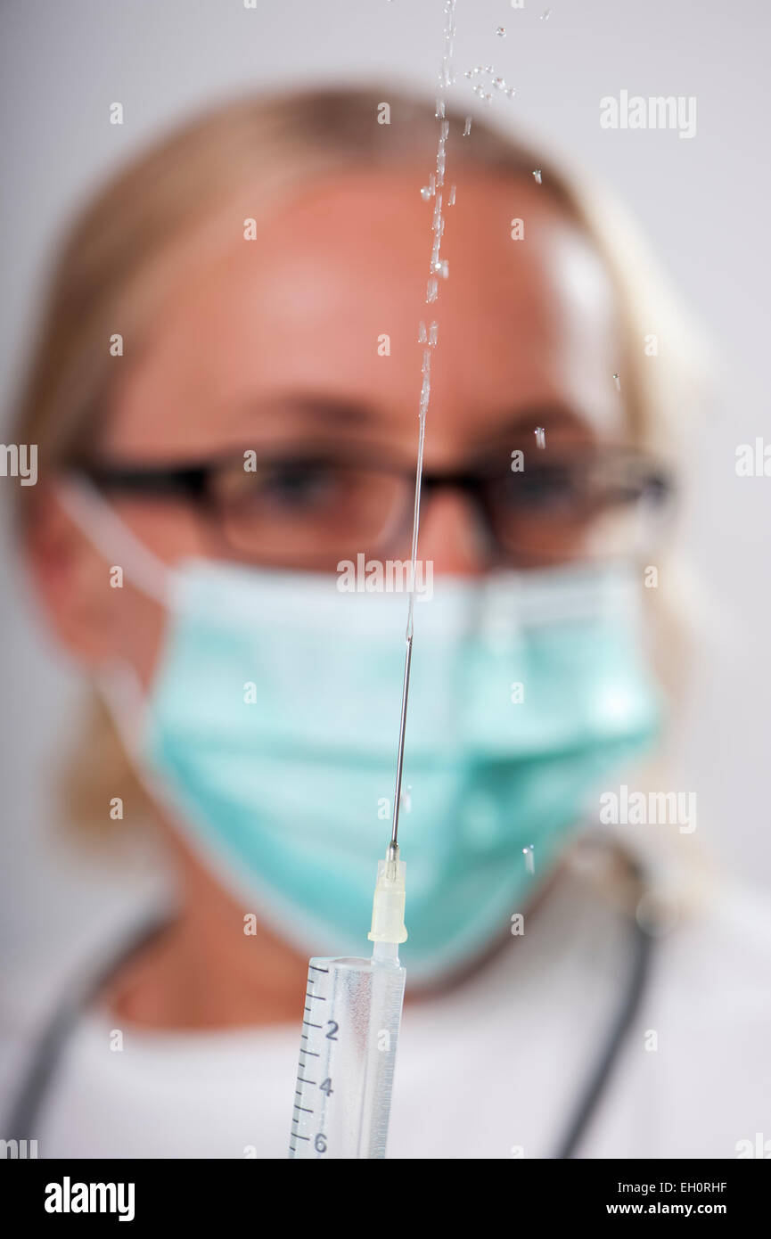 Female doctor testing injection Stock Photo