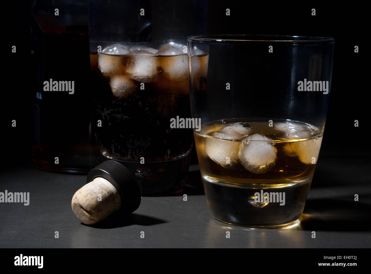 Whisky on the rocks and cola with ice cubes Stock Photo - Alamy