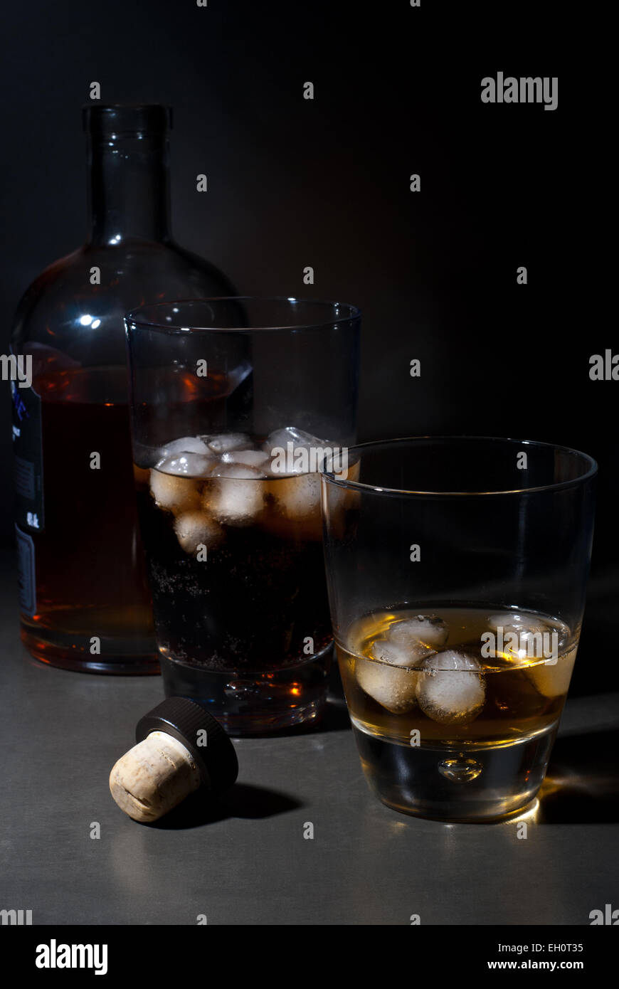 Whisky on the rocks and cola with ice cubes Stock Photo - Alamy