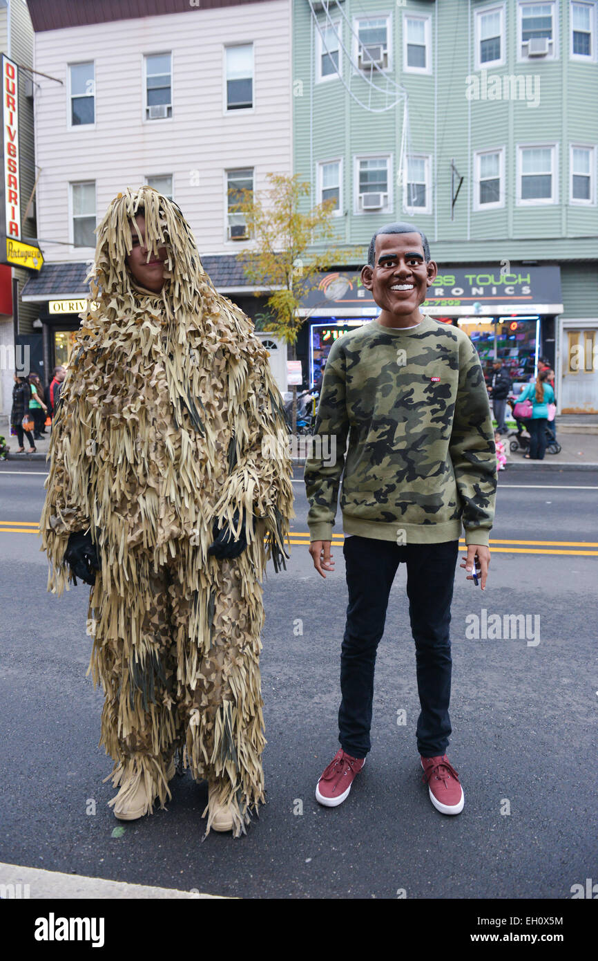 Young boy dressed as Obama e another one dressed as a bush posing in the streets of Newark, New Jersey. USA. Halloween 2013. Stock Photo