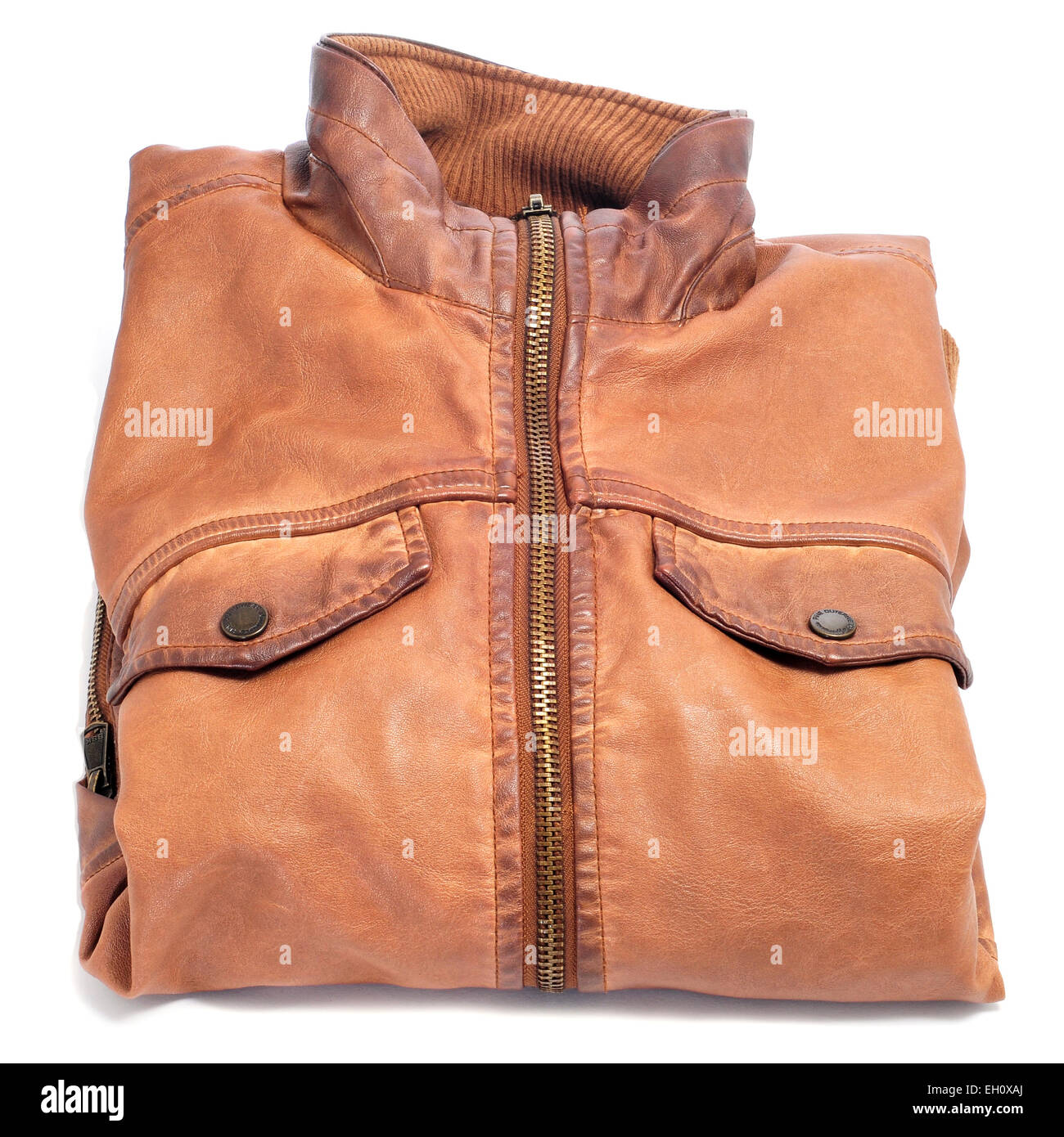 closeup of a folded brown worn leather jacket on a white background Stock Photo