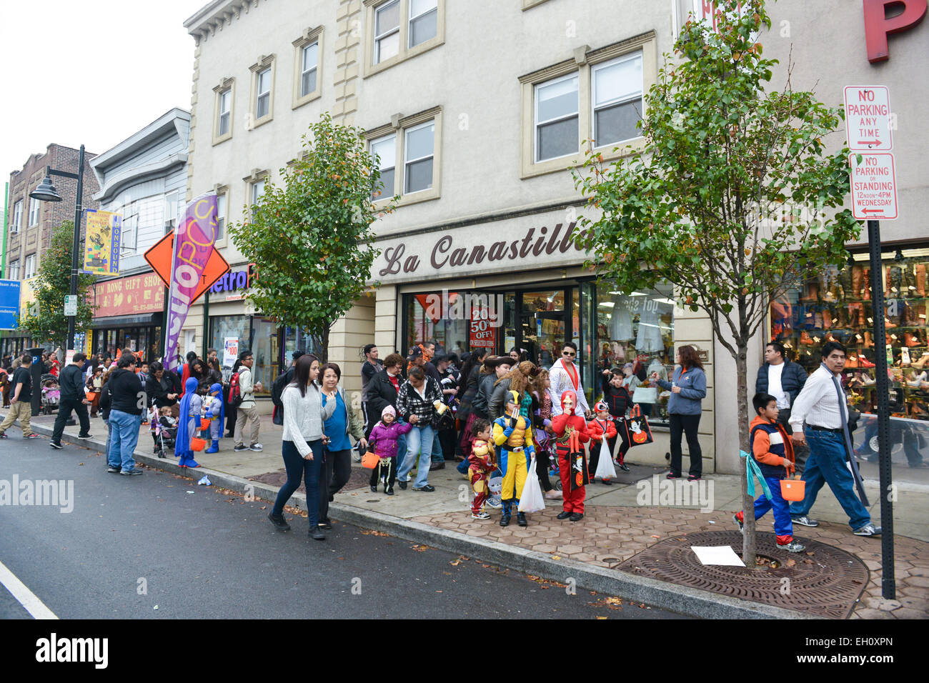 People in costumes walking down Ferry Street in Newark, New Jersey USA during the Halloween 2013. Stock Photo