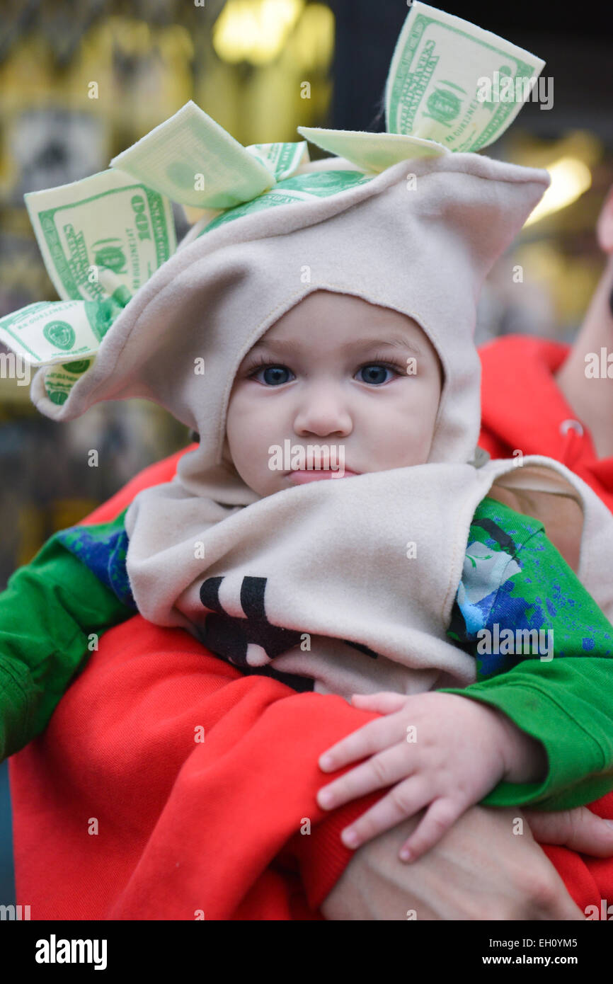 Baby dressed as a bag of money in the streets of Newark, New Jersey during Halloween 2013. Stock Photo
