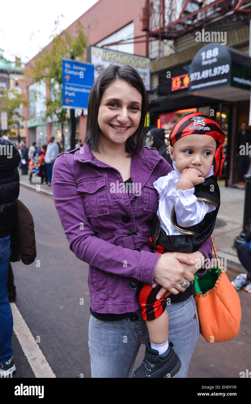 Young mother poses with her young son dressed as a pirate during halloween in streets of Newark, New Jersey 2013 Stock Photo