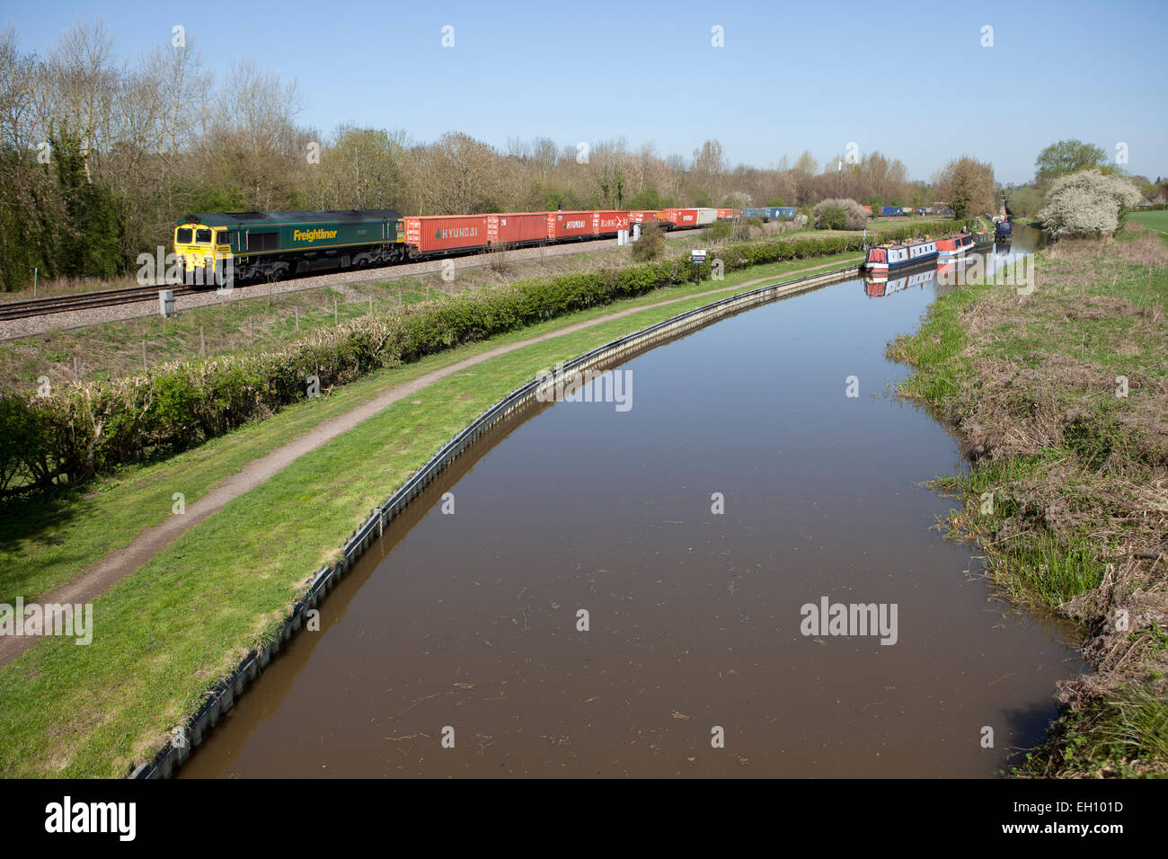 A passenger train runs by the Oxford Canal in Oxfordshire, England Stock Photo
