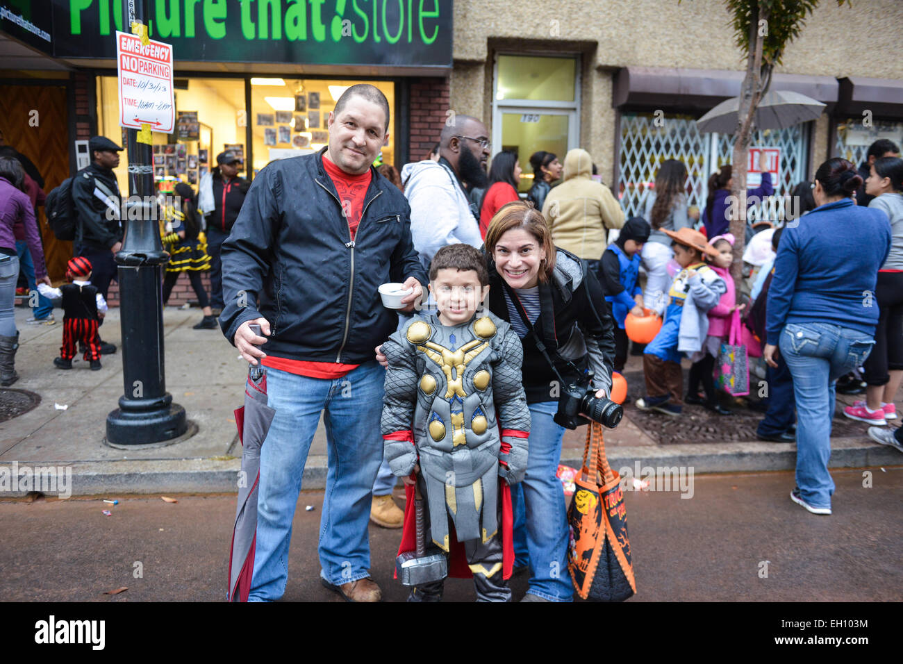 Parents pose with young son on Ferry Street during the halloween of 2013 in Newark, New Jersey. Stock Photo