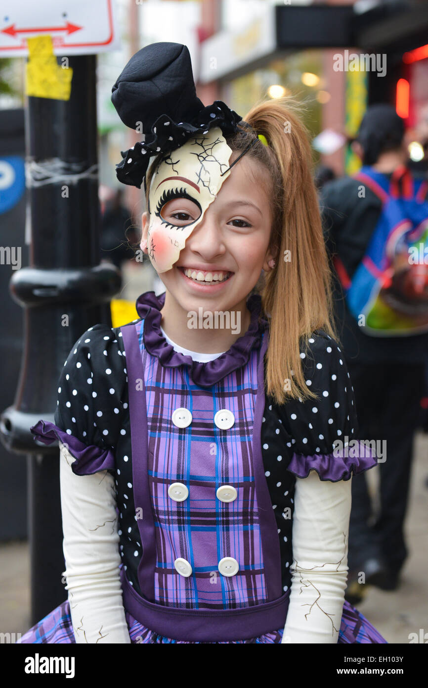 Young cute girl in a costume posing with a big smile on Ferry Street during the halloween 2013 in Newark, New Jersey. Stock Photo