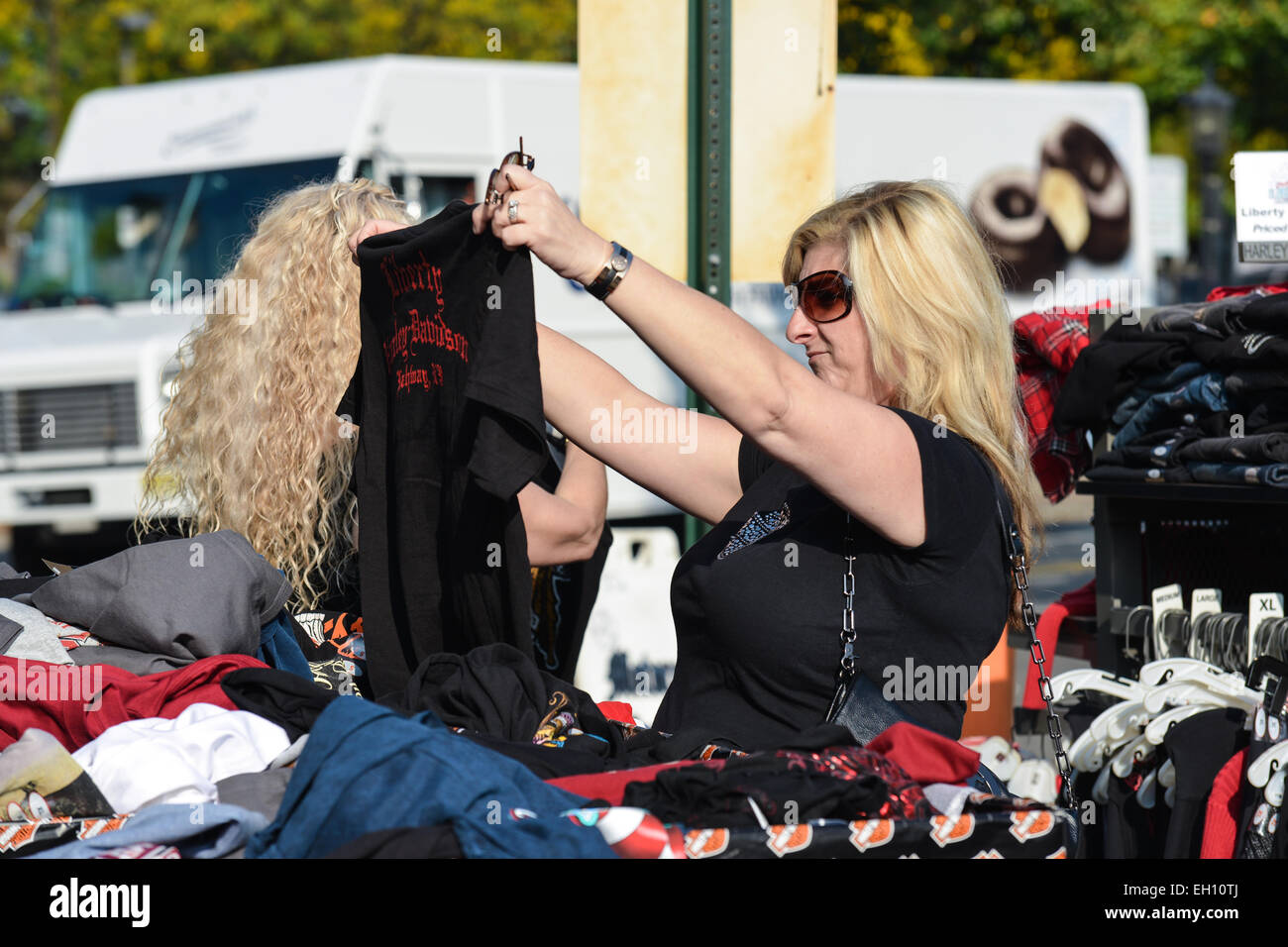 Woman checking a t-shirt out during the Liberty Harley Davidson anniversary party in Rahway, New Jersey. USA. Stock Photo