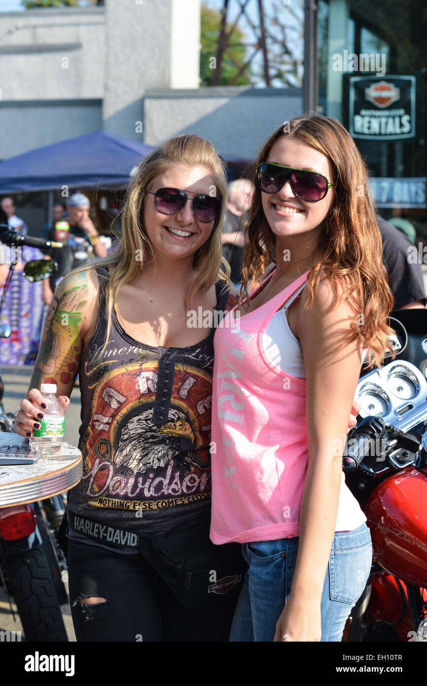 Two girls posing and smiling during the Liberty Harley Davidson anniversary party. Rahway, New Jersey. USA Stock Photo