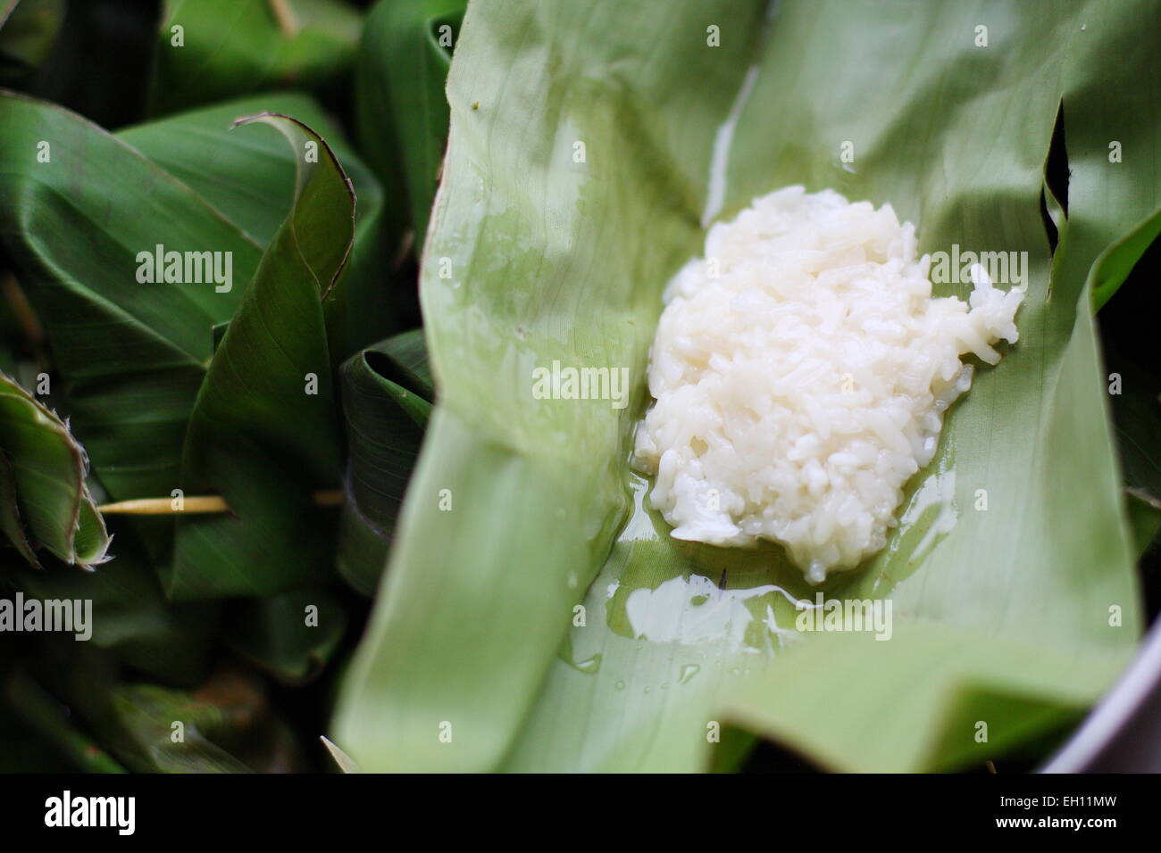 Fermented  white glutinous rice wrapped in banana leaves Stock Photo