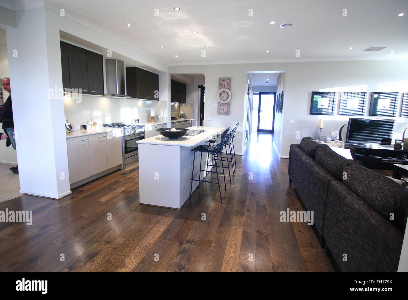 Modern White Kitchen with wooden flooring Stock Photo - Alamy