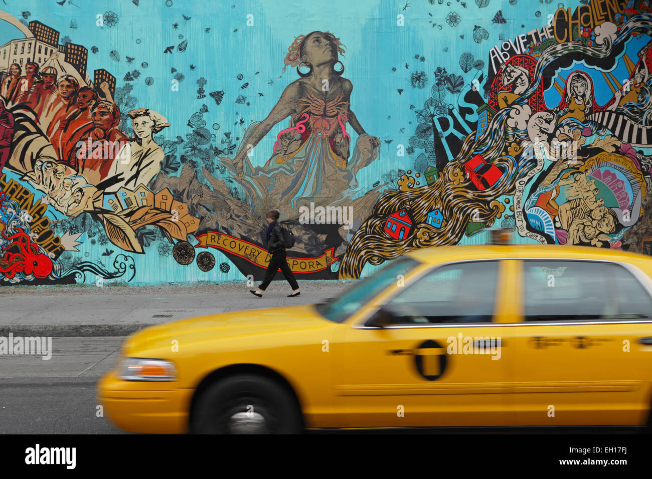 A yellow cab speeds past a colorful mural installed by Swoon on the Bowery Mural Wall on Houston Street on the Lower East Side Stock Photo